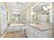 Spa-like bathroom with soaking tub, double vanity, and marble floors at 3930 Red Rock Way, Sarasota, FL 34231