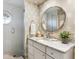 Modern bathroom with a walk-in shower, stylish vanity, and patterned wallpaper at 3930 Red Rock Way, Sarasota, FL 34231