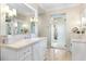 Elegant bathroom with double vanity, marble countertops and a large shower at 3930 Red Rock Way, Sarasota, FL 34231