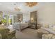 Main bedroom with canopy bed, sitting area, and French doors to patio at 3930 Red Rock Way, Sarasota, FL 34231