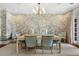 Formal dining room with light walls, a decorative wallpaper, and a large dining table at 3930 Red Rock Way, Sarasota, FL 34231