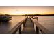 Wooden dock extending over calm water at sunset at 3930 Red Rock Way, Sarasota, FL 34231