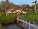 Wooden walkway to waterfront home at sunset at 3930 Red Rock Way, Sarasota, FL 34231