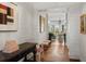 Bright entryway with herringbone floors, white shiplap walls, and a glimpse of the living room at 3930 Red Rock Way, Sarasota, FL 34231