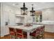 Gourmet kitchen boasts a center island, white cabinets, and marble countertops at 3930 Red Rock Way, Sarasota, FL 34231