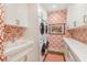 Bright laundry room with white cabinets, a utility sink, and patterned wallpaper at 3930 Red Rock Way, Sarasota, FL 34231