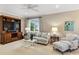 Cozy living area with comfortable seating, a white coffee table, and built in shelving at 3930 Red Rock Way, Sarasota, FL 34231