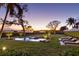 Relaxing pool and spa area with lounge chairs, lush landscaping, and water views at 3930 Red Rock Way, Sarasota, FL 34231