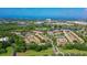 Aerial view of Pinestone community, showing building exteriors, landscaping, and tennis courts at 4250 Players Pl # 2625, Sarasota, FL 34238