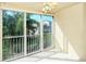 Condo balcony with sliding glass doors, tiled floor, and view of trees at 4250 Players Pl # 2625, Sarasota, FL 34238