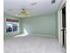 Bright bedroom with large window, ceiling fan, and neutral carpeting at 4250 Players Pl # 2625, Sarasota, FL 34238