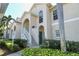 Two-story building exterior with lush landscaping and a welcoming entrance at 4250 Players Pl # 2625, Sarasota, FL 34238