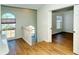 Upstairs hallway with wood flooring and view to kitchen at 4250 Players Pl # 2625, Sarasota, FL 34238