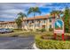 Weybridge community entrance with lush landscaping and signage at 4402 Weybridge St # 95, Sarasota, FL 34235