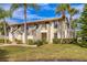 Two-story condo building with lush landscaping and palm trees at 4402 Weybridge St # 95, Sarasota, FL 34235