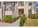 Condo entrance with walkway, landscaping, and palm trees at 4402 Weybridge St # 95, Sarasota, FL 34235