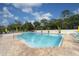 Community pool area with plenty of lounge chairs at 4402 Weybridge St # 95, Sarasota, FL 34235