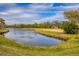 Serene view of a pond or canal alongside a golf course at 4402 Weybridge St # 95, Sarasota, FL 34235