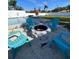 Relaxing fire pit area with teal chairs in the backyard at 4609 19Th W St, Bradenton, FL 34207