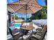 Striped patio umbrella and outdoor dining set at 4609 19Th W St, Bradenton, FL 34207