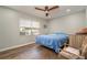 Bedroom with hardwood floors, a ceiling fan, and a large window at 4845 Rilma Ave # 122, Sarasota, FL 34234