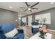 Bright living room featuring hardwood floors, comfortable blue chairs, and a dining area in the background at 4845 Rilma Ave # 122, Sarasota, FL 34234