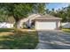 House exterior featuring a two-car garage and well-maintained lawn at 4927 69Th E Ct, Palmetto, FL 34221