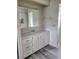 Bathroom vanity with white cabinets and gray flooring at 4969 Pebble Beach Ave, Sarasota, FL 34234