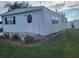 Side view of a white mobile home with landscaping at 4969 Pebble Beach Ave, Sarasota, FL 34234