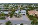 Aerial view of a waterfront home with a private dock and lush landscaping at 505 69Th St, Holmes Beach, FL 34217