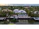 Aerial view of a waterfront home with a private pool and boat dock at sunset at 505 69Th St, Holmes Beach, FL 34217