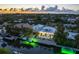 Aerial view of a waterfront home with a private pool and boat dock at dusk at 505 69Th St, Holmes Beach, FL 34217