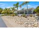 Landscaped backyard with a retaining wall and tropical plants at 505 69Th St, Holmes Beach, FL 34217