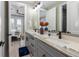 Guest bathroom with double vanity and gray cabinets at 505 69Th St, Holmes Beach, FL 34217