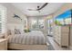 Main bedroom with king-size bed, private balcony, and large TV at 505 69Th St, Holmes Beach, FL 34217