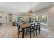 Open dining area with wooden table and chairs, overlooking living room and pool at 505 69Th St, Holmes Beach, FL 34217