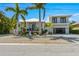 Modern two-story home with a two-car garage and tropical landscaping at 505 69Th St, Holmes Beach, FL 34217