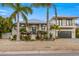 Two-story house with palm trees and manicured landscaping at 505 69Th St, Holmes Beach, FL 34217