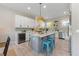 Modern kitchen with white cabinets, a large island, and stainless steel appliances at 505 69Th St, Holmes Beach, FL 34217