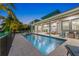 Inviting pool area with patio and lounge chairs at dusk at 505 69Th St, Holmes Beach, FL 34217