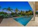 Tranquil pool scene at night with surrounding palm trees at 505 69Th St, Holmes Beach, FL 34217