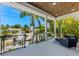 Relaxing covered porch overlooking a lush, tropical neighborhood at 505 69Th St, Holmes Beach, FL 34217