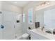 Clean bathroom with a glass shower, white vanity, and window at 5204 Title Row Dr, Bradenton, FL 34210