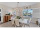 Bright dining room with white table and chairs, water views, and plantation shutters at 5204 Title Row Dr, Bradenton, FL 34210