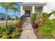 Landscaped entry with stone walkway and lush tropical plants at 5204 Title Row Dr, Bradenton, FL 34210