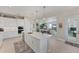 Bright kitchen with white cabinets, large island, and views to the living area at 5204 Title Row Dr, Bradenton, FL 34210