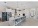 Gourmet kitchen with white cabinets, quartz countertops, and a wine cooler at 5204 Title Row Dr, Bradenton, FL 34210