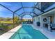 Luxury pool and patio with screened enclosure and water views at 5204 Title Row Dr, Bradenton, FL 34210