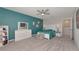 Bedroom with teal accent wall, ceiling fan, and ample closet space at 5216 Adega Way, Bradenton, FL 34211