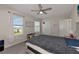 Bright bedroom featuring a large bed, window seating and a ceiling fan at 5216 Adega Way, Bradenton, FL 34211